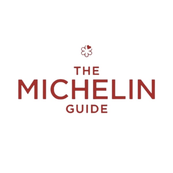 The Michelin Guide logo, featuring a red stylized flower and text on a white background.