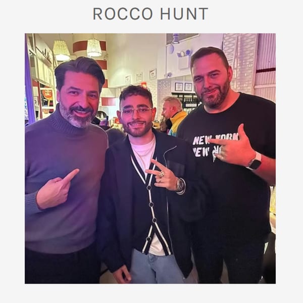 Three men posing for a photo inside Ribalta, an Italian restaurant.